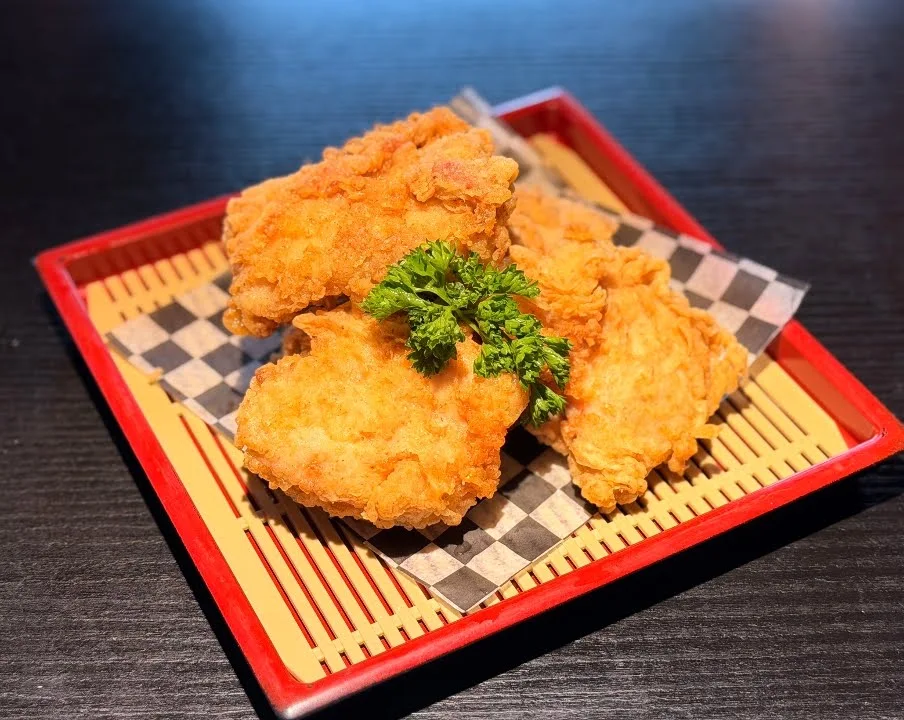 Golden crispy Korean fried chicken served in a bamboo basket at Kimchi Sushi, northwest Winnipeg