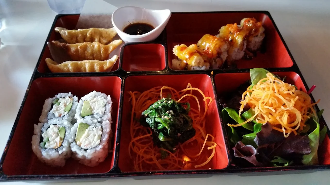 Bento box with gyozas, sushi roll, seaweed salad and a dynamite roll at Kimchi Sushi, Winnipeg